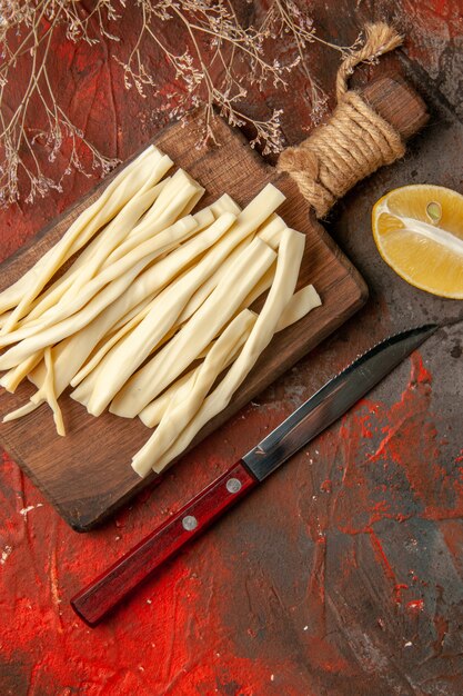 Top view fresh cheese sliced on wooden desk on a dark background