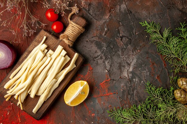 Top view fresh cheese sliced on wooden desk on dark background