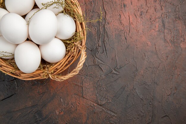 Top view fresh chicken eggs inside basket on dark table food animal healthy life color photo farm free space for text