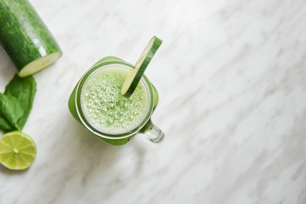 Top view of a fresh cucumber smoothie jar mug