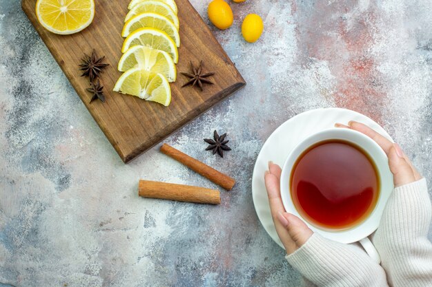 Top view fresh cut lemons cinnamon sticks star anises on chopping board