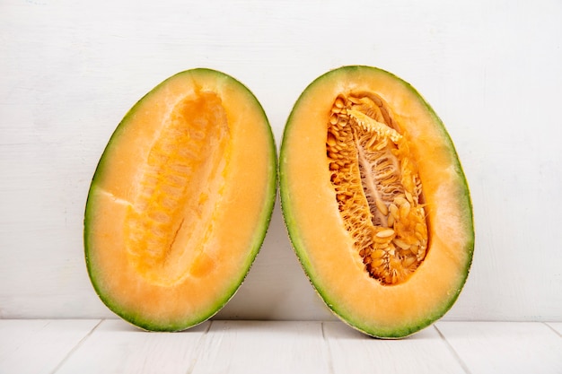 Top view of fresh and delicious cantaloupe melon slices on white