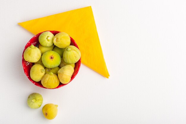 Top view fresh figs sweet and delicious fetuses inside red plate on white surface