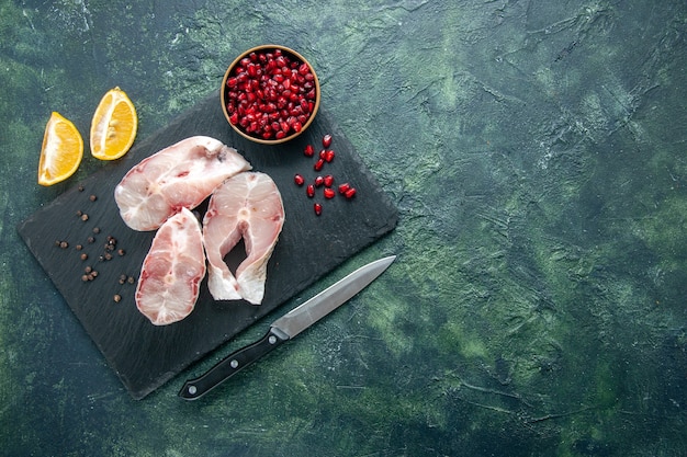 Top view fresh fish slices on dark background ocean meat seafood sea meal dish food pepper water raw