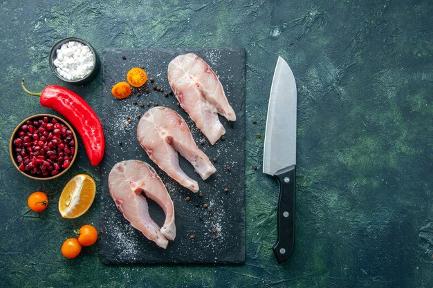 Top view fresh fish slices on the dark background seafood ocean meat sea meal dish salad water pepper food