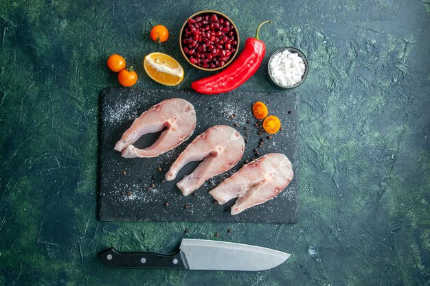 Top view fresh fish slices on a dark table seafood ocean meat sea meal dish salad water pepper food