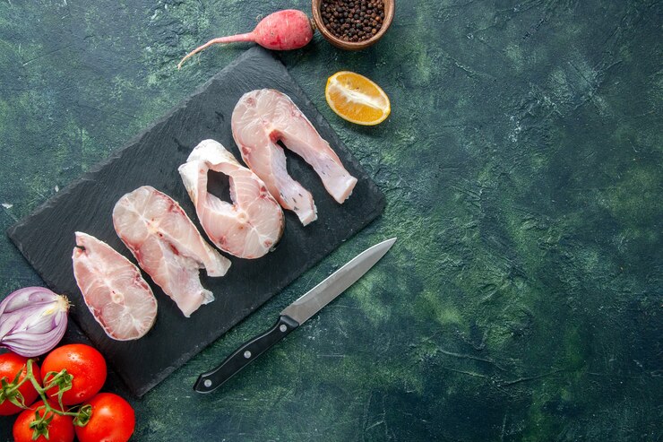 Бесплатный Фотография вид сверху кусочки свежей рыбы с красными помидорами на темно-синем фоне мясо океана морепродукты еда перец водяное блюдо морская мука