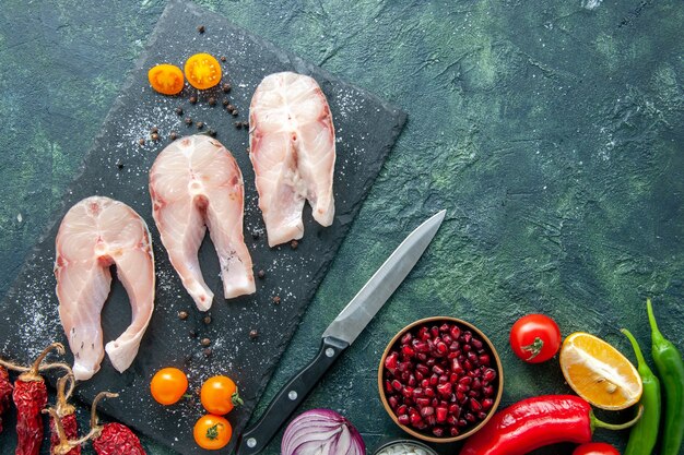 Top view fresh fish slices with vegetables on dark background dish salad seafood ocean meat sea pepper food water meal