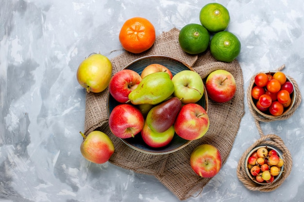 Top view fresh fruits apples and mango on the light white desk