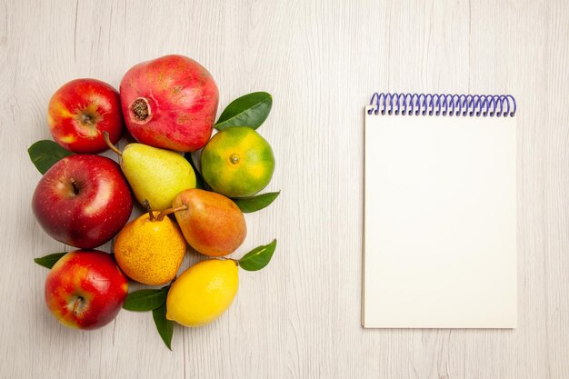 Top view fresh fruits apples pears and other fruits on white desk fruit ripe tree color mellow many fresh