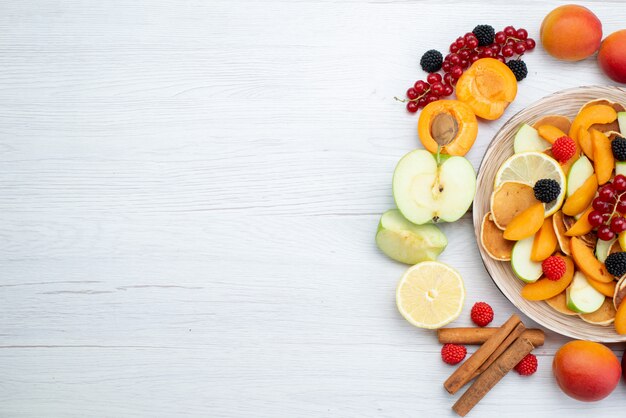 A top view fresh fruits colorful and ripe on the wooden desk and white background fruits color food photo