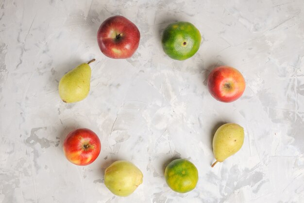 Top view fresh fruits composition lined on white background