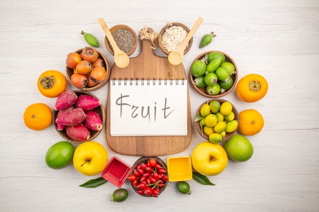 Top view fresh fruits composition on white background