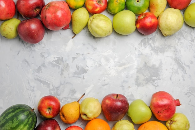 Top view fresh fruits composition on the white background