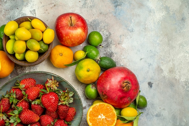 Top view fresh fruits different mellow fruits on the white background health tree color tasty photo berry citrus ripe