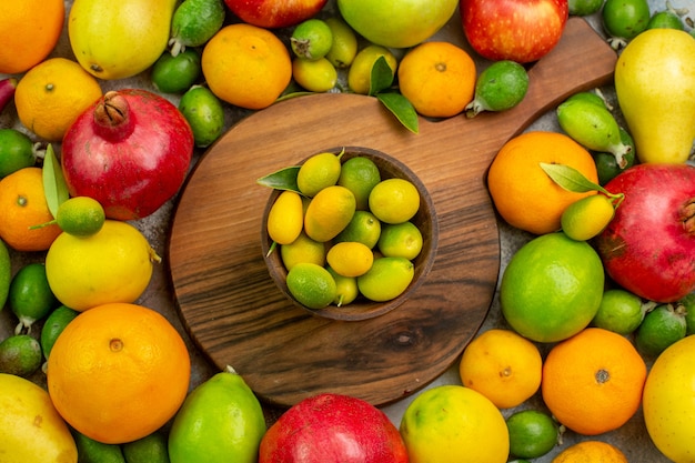 Top view fresh fruits different ripe and mellow fruits on the white background color berry health photo tasty diet