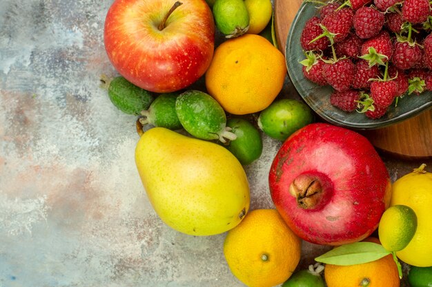 Top view fresh fruits different ripe and mellow fruits on a white background photo tasty diet berry health color