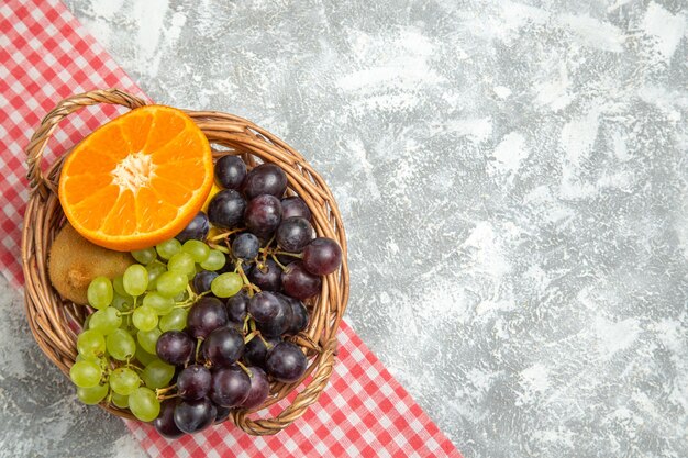 흰색 표면 과일 익은 부드러운 신선한 비타민에 바구니 안에 있는 상위 뷰 신선한 과일 포도와 오렌지