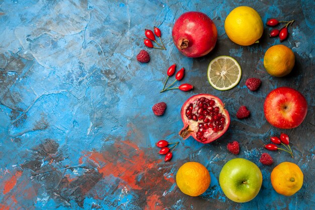 Top view fresh fruits lined on blue background