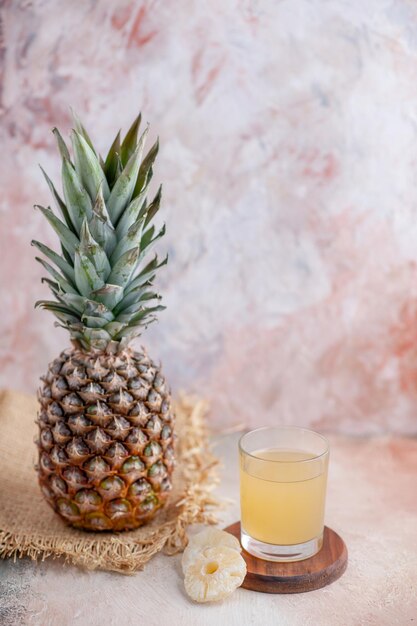 Top view of fresh grapefruit on brown fabric and fruit juice on pastel colors background