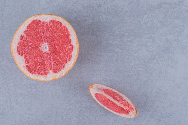 Top view of fresh grapefruit on grey surface