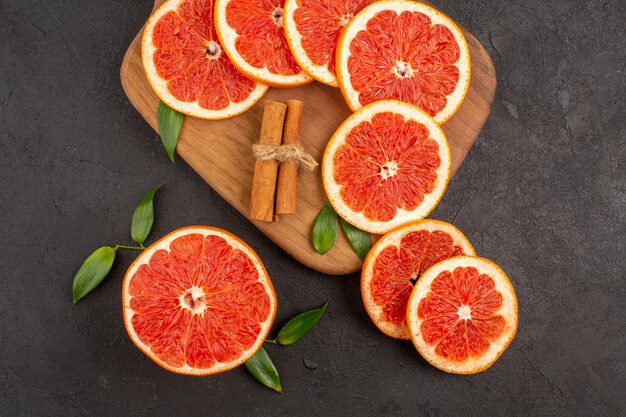 Top view fresh grapefruit slices on a dark background