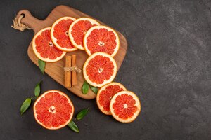Top view fresh grapefruit slices on dark background