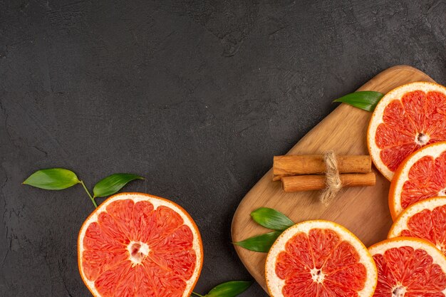 Top view fresh grapefruit slices on dark background