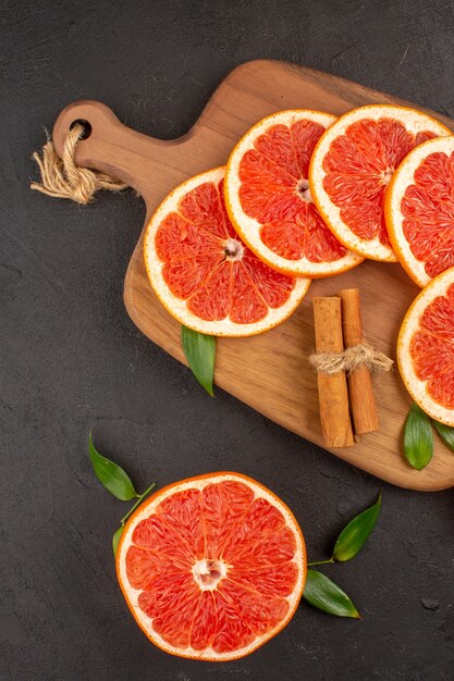 Top view fresh grapefruit slices on the dark background