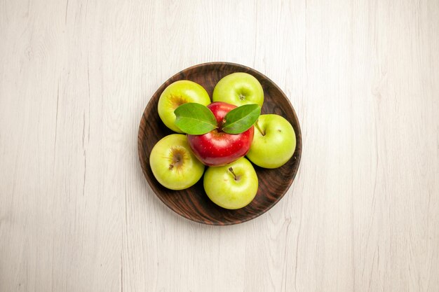 Top view fresh green apples ripe and mellow fruits on white desk fruit color fresh plant red tree