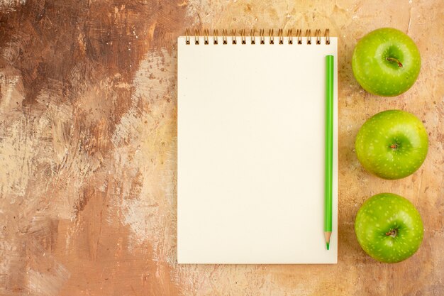 Top view fresh green apples with notepad