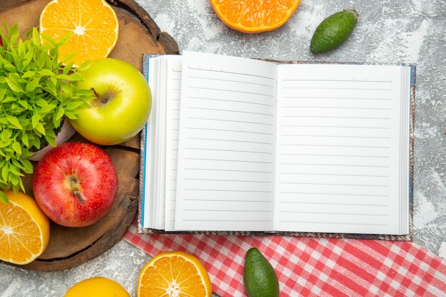 Top view fresh green apples with sliced oranges on white surface apples fruit ripe mellow fresh