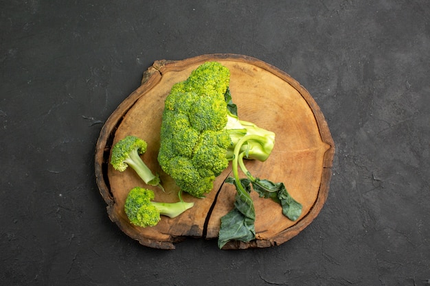 Top view fresh green broccoli plant from cabbage on dark table salad ripe health