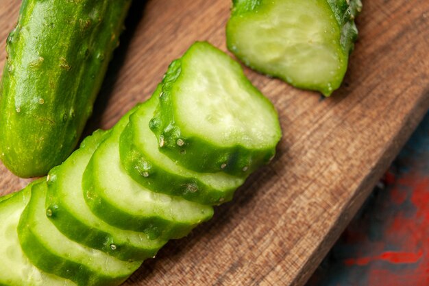 Top view fresh green cucumbers sliced on the blue background