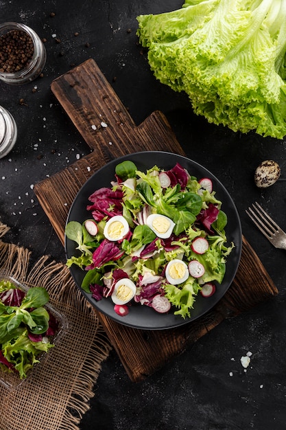 Top view fresh green salad in dark bowl