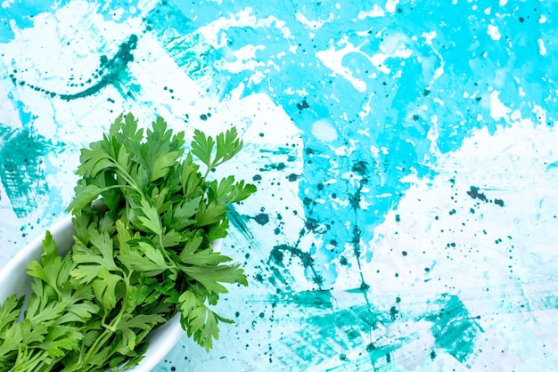 top view of fresh greens isolated inside plate on bright-blue desk,  green leaf product food meal