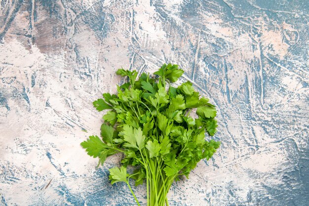 Top view fresh greens on a light-blue background