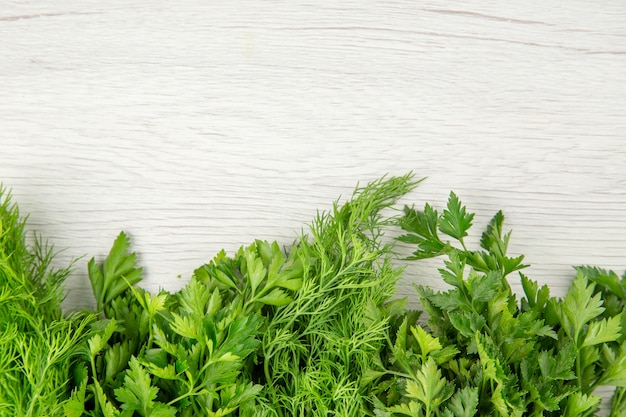 Top view fresh greens on a white background