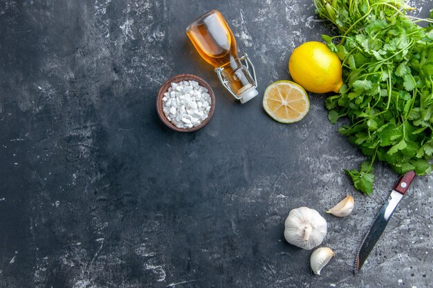 Top view fresh greens with garlic on grey background