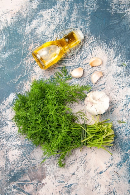 Top view fresh greens with oil and garlic on light background