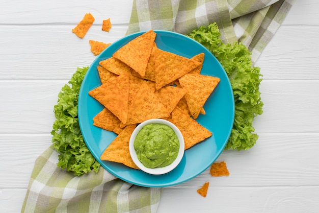 Top view fresh guacamole with nachos on the table