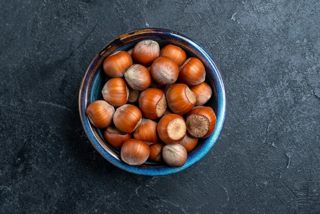 Top view fresh hazelnuts inside little pot on dark surface nut hazelnut walnut snack peanut