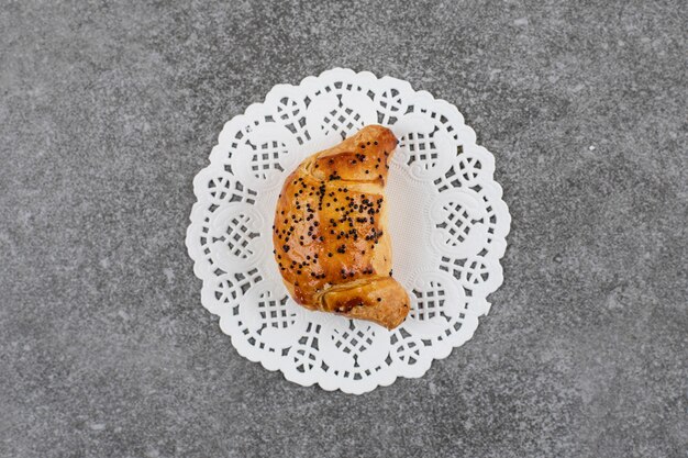 Top view of fresh homemade cookie on white napkin over grey surface