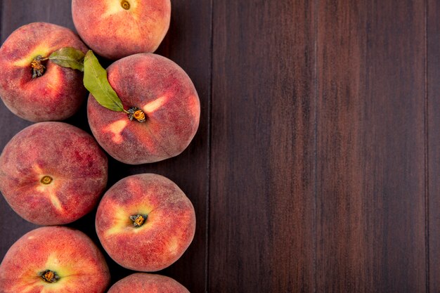 Top view of fresh juicy delicious peaches on wood with copy space