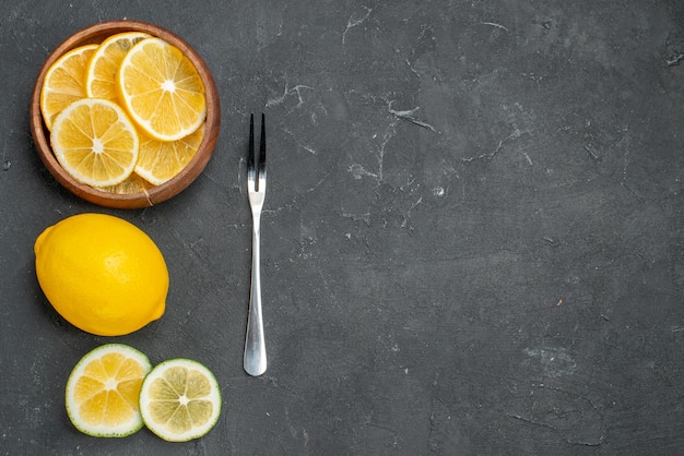 Top view fresh lemon slices on dark surface