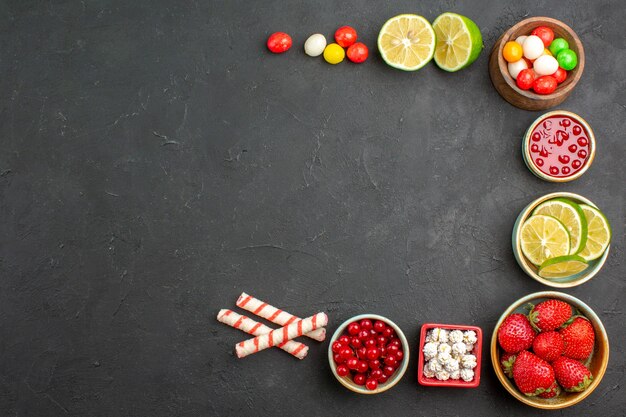 Top view fresh lemon slices with candies and fruits