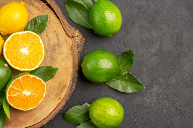 Top view fresh lemons on dark table lime sour fruits citrus