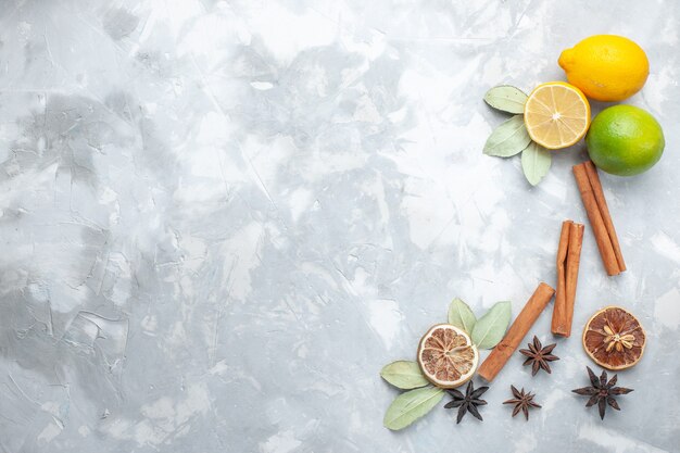 Top view fresh lemons juicy and sour with cinnamon on the white desk tropic exotic fruit citrus