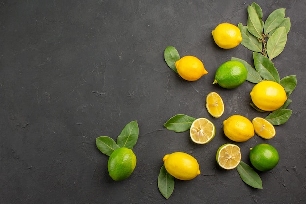 Top view fresh lemons sour fruits on dark table citrus lime fruit