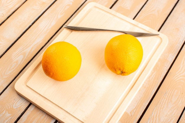 A top view fresh lemons sour ripe mellow citrus juicy tropical vitamine yellow on the cream rustic desk